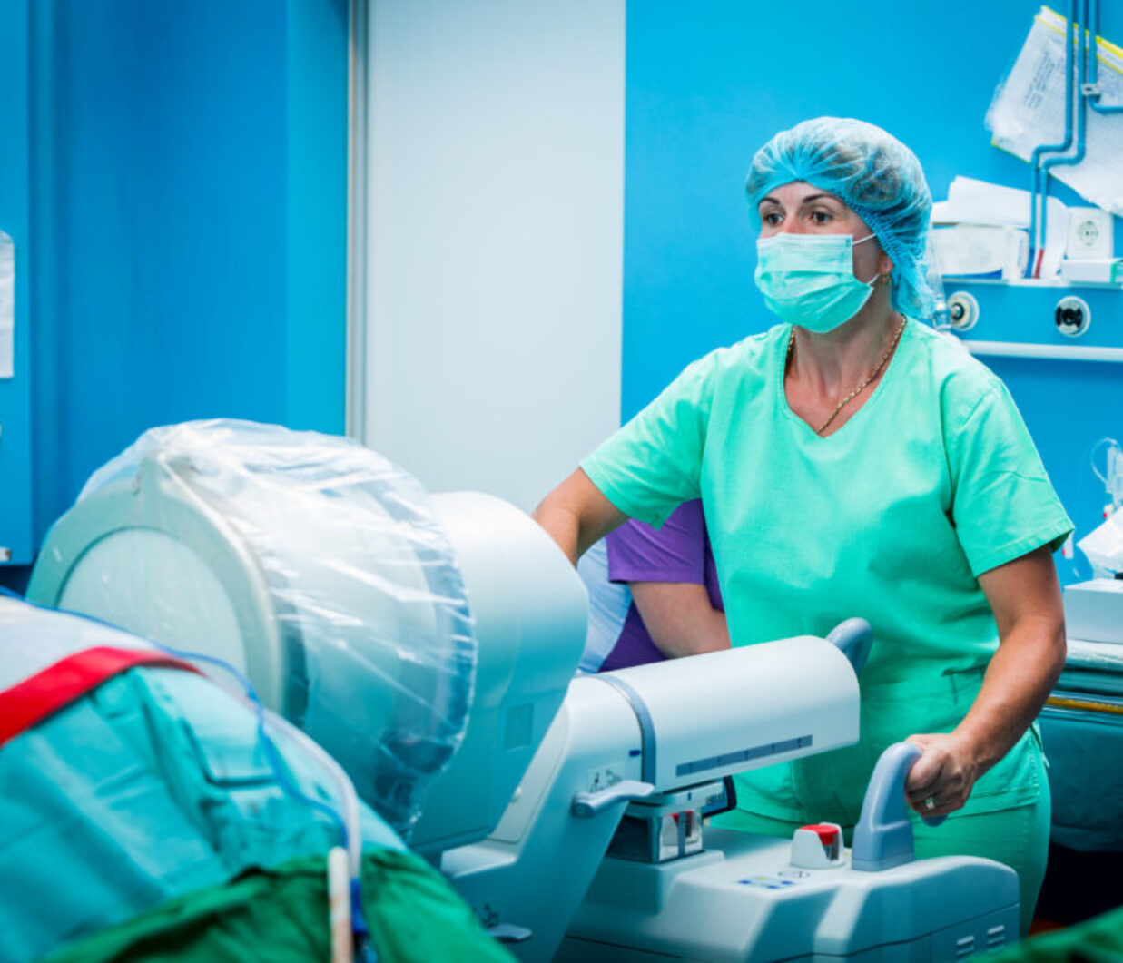 Medical assistant with a c-arm fluoroscope verifying spine surge